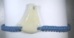 All natural Hand carved Sail Boat Tagua charm on a hand woven cotton bracelet by Tu y Yo